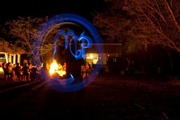 MCP written in light painting at night around a campfire