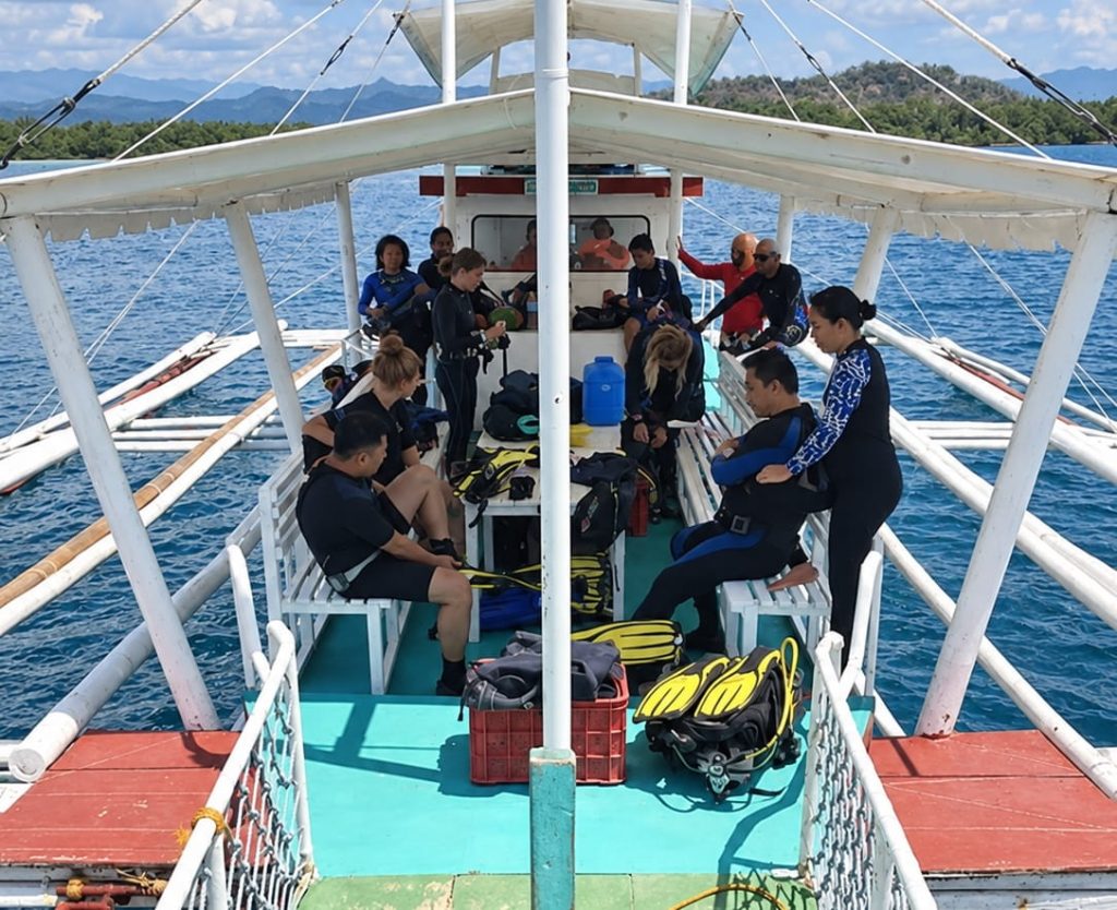 MCP dive team gearing up aboard a boat during the Bais LGU dive training expedition
