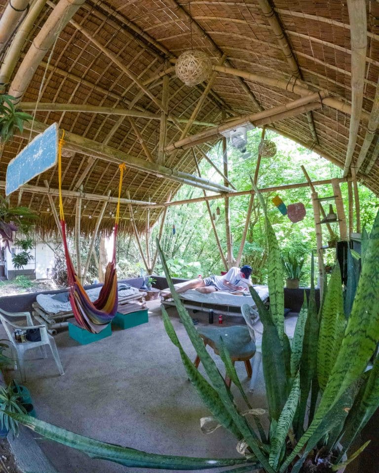 Cosy open-air lounge area with hammocks and a thatched roof at MCP's base
