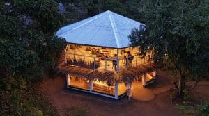 MCP's two-story open-air communal area lit up at dusk, seen from above