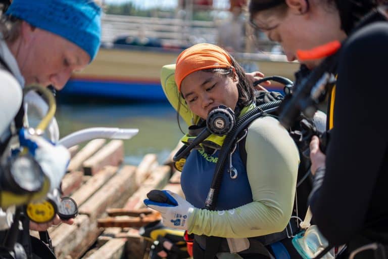 MCP divers checking their gear before a dive