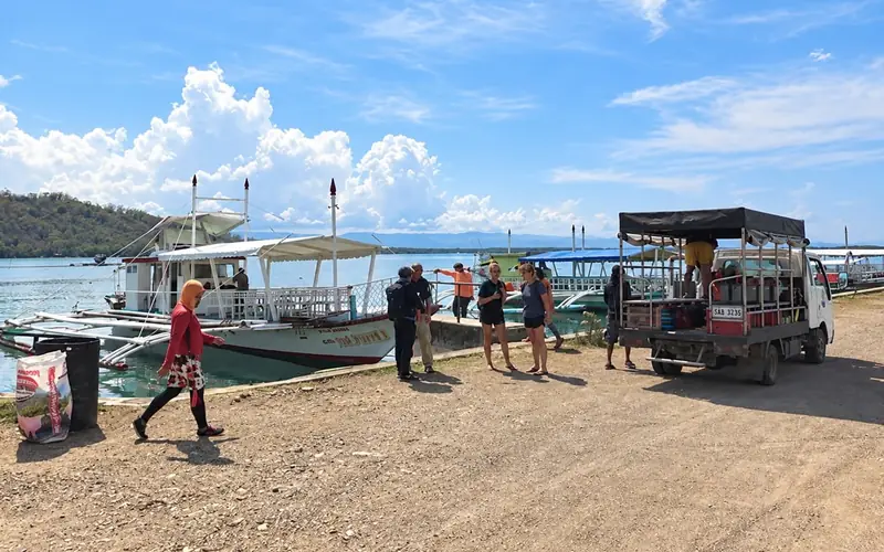 Loading dive gear at the Bais jetty for a training day with the municipal dive team