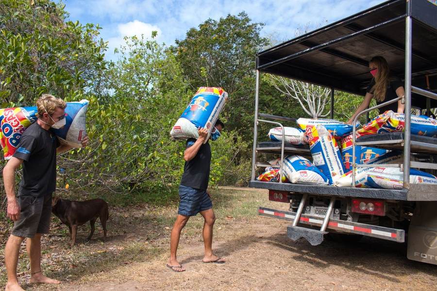 MCP staff carrying sacks of rice from a truck