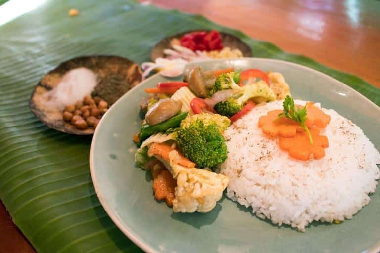 Vegetable chop suey with rice, served on a banana leaf